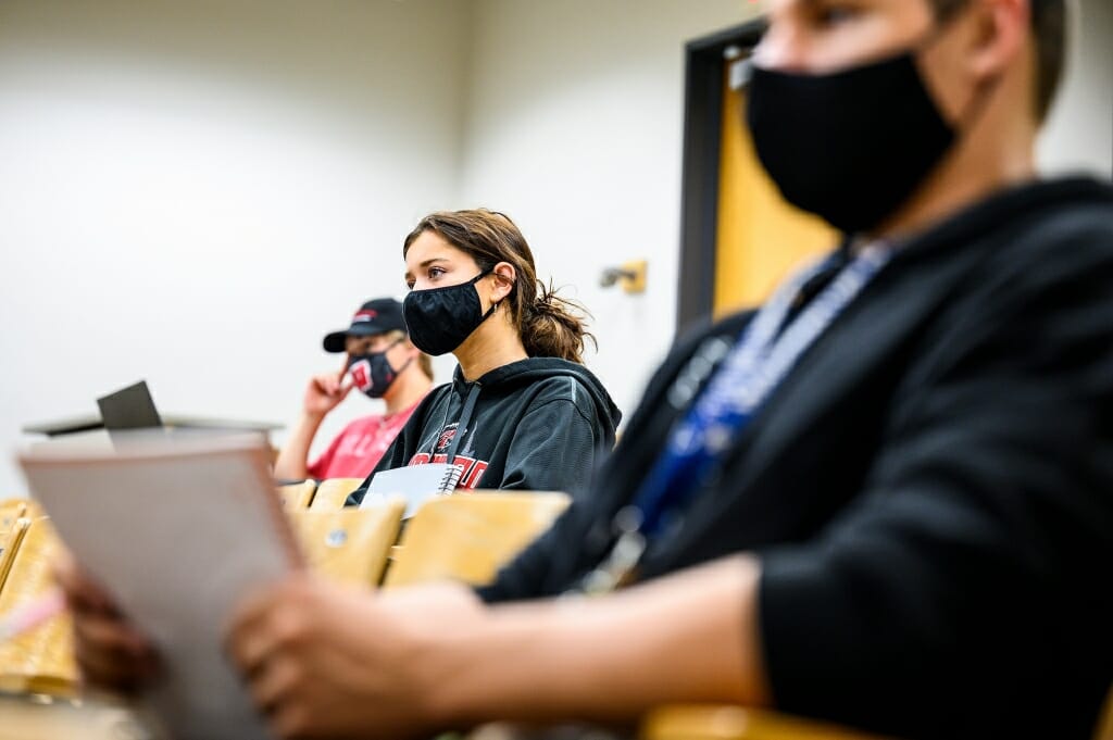 Students in class follow safety precautions to prevent the spread of COVID-19.