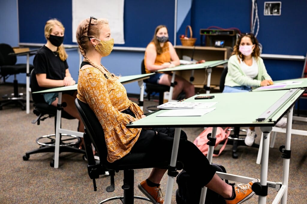 Students talk and listen to one another as they make introductions during a class in Vilas Hall.