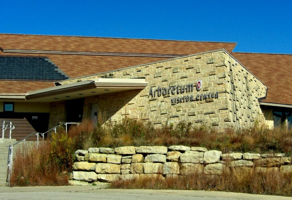 Exterior of main entrance to visitor center with rock wall and native plants