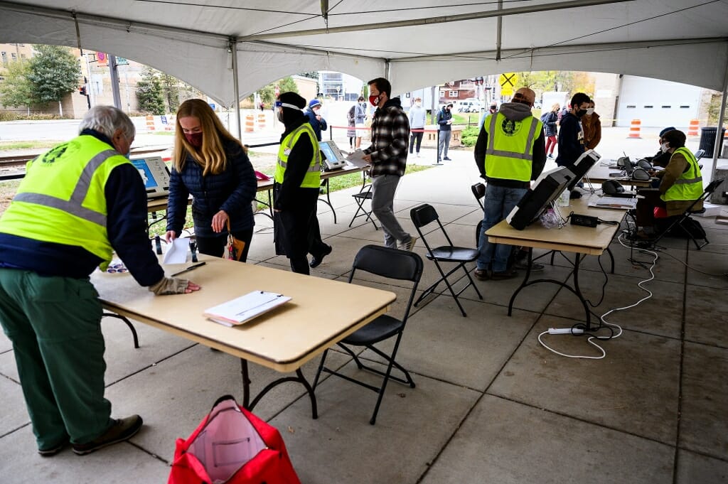 Staff from the City of Madison Clerk’s Office help students vote. 