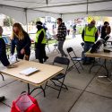 Staff from the City of Madison Clerk’s Office help students vote. 