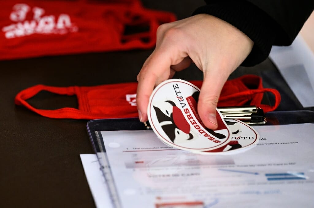 A student collects a #BadgersVote sticker after casting a vote.