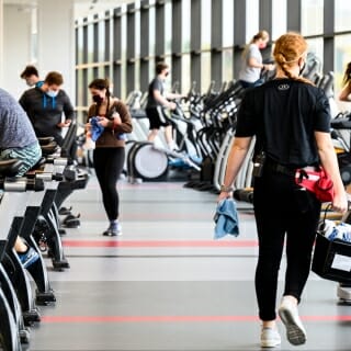 Person wiping down cardio machine