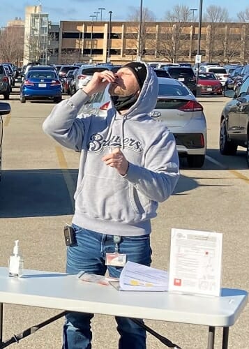 Barr putting swab in his nostril