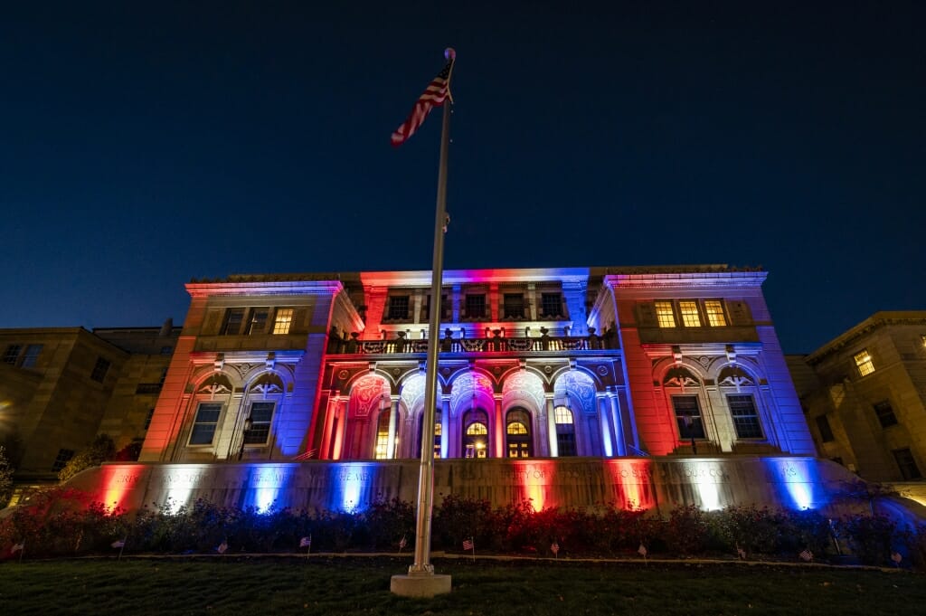 Memorial Union illuminated in red, white and blue lights