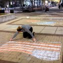 Maloney puts the finishing touches on an American flag, in chalk.
