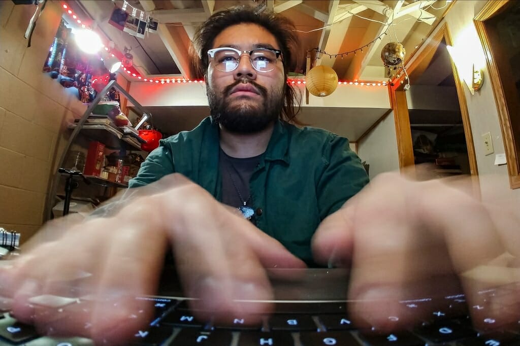 Brian Huynh typing on his computer