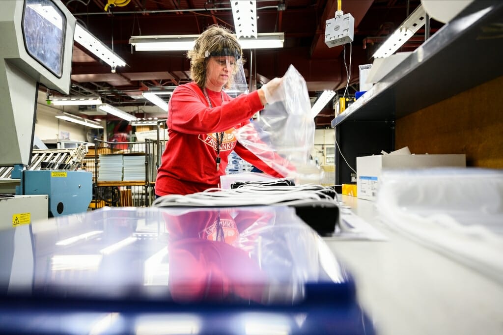 Person assembling face shield