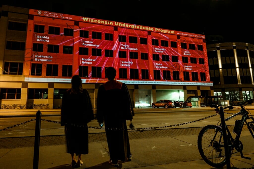 Building covered in red light and names