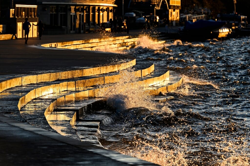 Waves crashing against shore wall