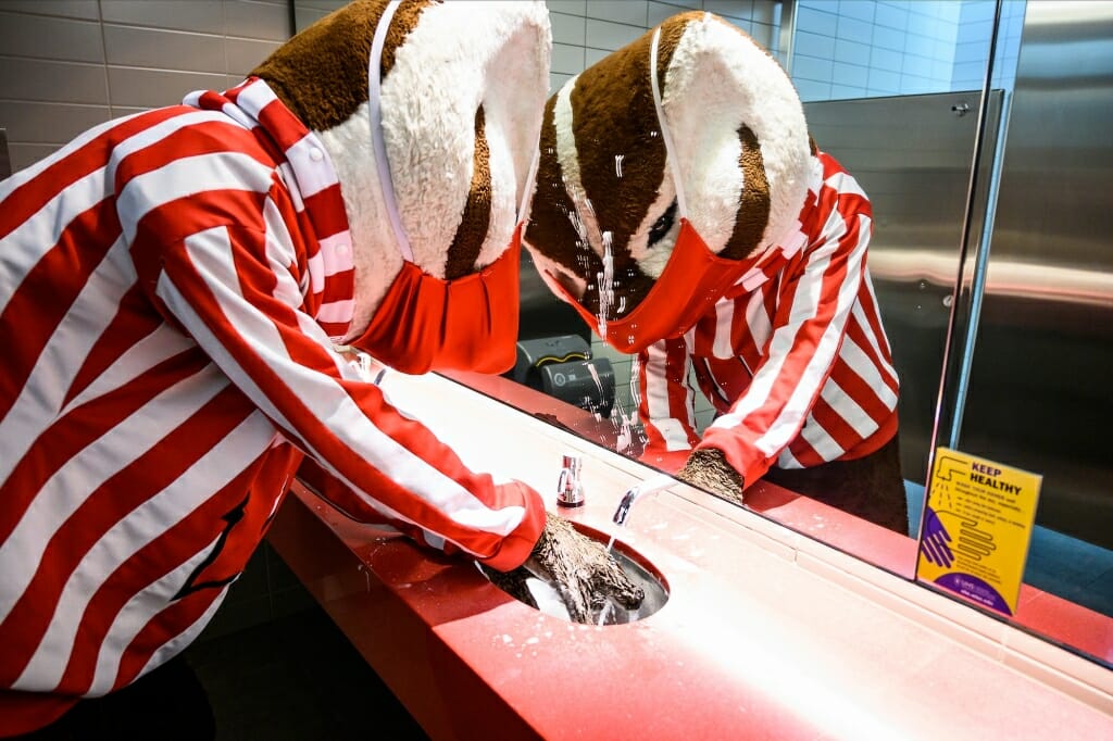 Bucky Badger washing hands at a sink