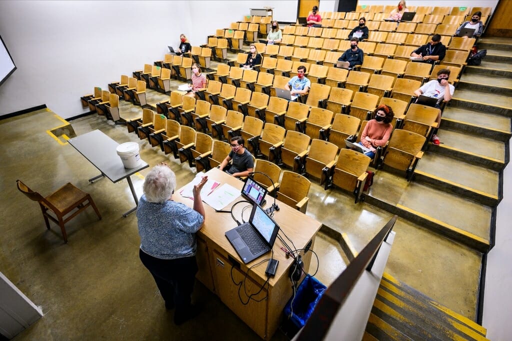 Lecture hall with a few students seated far apart