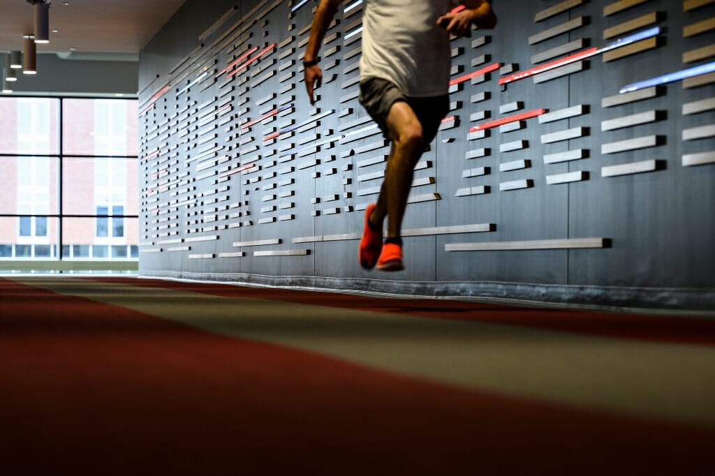 Person running on indoor track