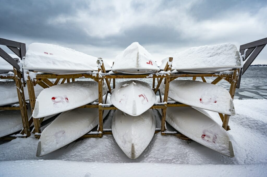 Several white sailboats resting on a rack