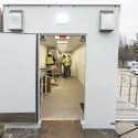 Workers install a lab fume hood on the lab.