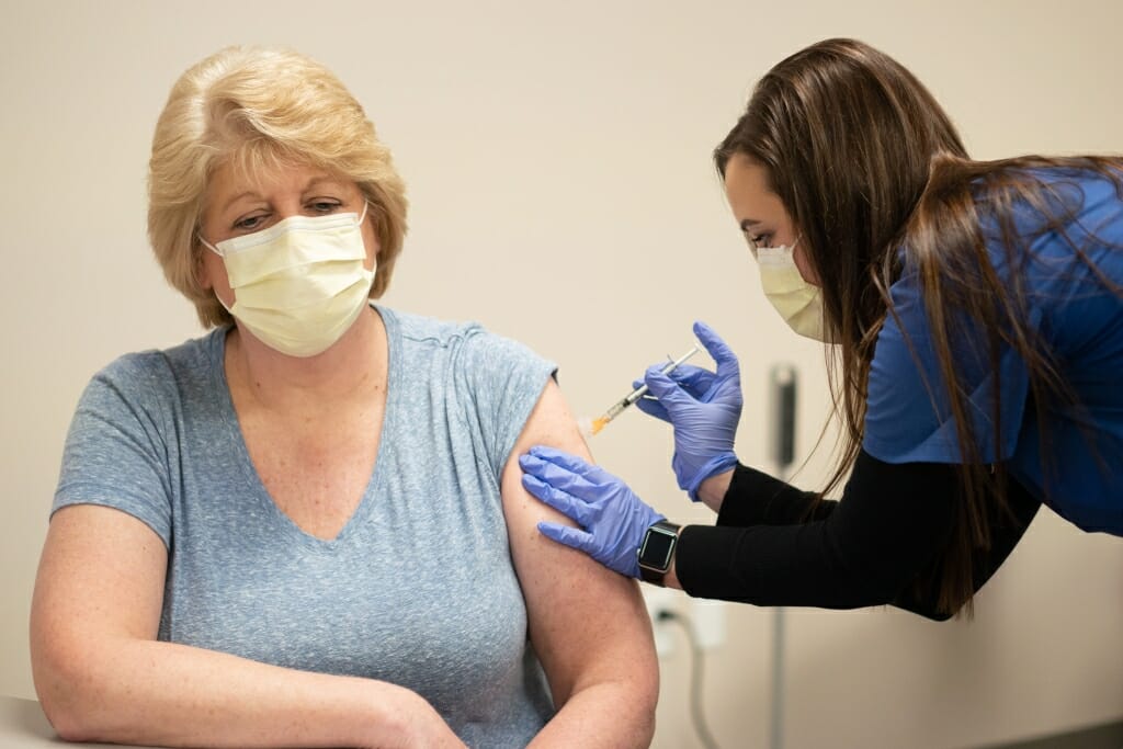 To master injecting the COVID-19 vaccines, UW Health staff members are practicing by injecting colleagues (and sometimes fruit) with a saline solution.