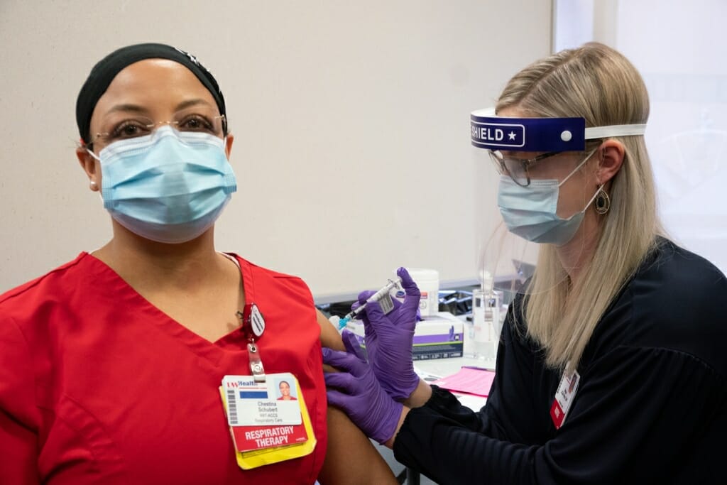 Respiratory therapist Tina Schubert became the first of UW Health’s healthcare heroes to receive the Pfizer COVID-19 vaccine at approx. 2:30 p.m. on Monday, Dec. 14, 2020. The vaccine was delivered by Megan LeClair-Netzel, manager for UW Health’s employee health services.