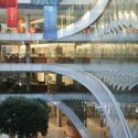 Banners hang from the ceiling as glass-paneled walls reflect a view of the Town Center atrium of the Wisconsin Institutes for Discovery (WID) at the University of Wisconsin-Madison on Nov. 14, 2012. (Photo by Jeff Miller/UW-Madison)