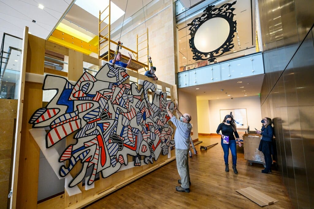 At center, Roger Machin, with Methods & Materials Inc. of Chicago, directs the installation.