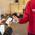 UW student Sam Kavajecz submits his sample to a COVID-19 saliva test at the University of Wisconsin-Madison on January 14, 2021. During the Spring 2021 semester, students will be required to take two saliva tests per week as part of the Safer Badgers COVID-19 response plan. (Photo by Bryce Richter / UW-Madison)