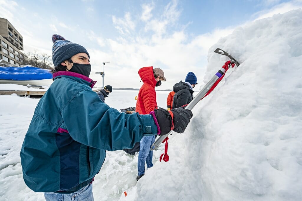 Student Hernan Ballard sinks an ice axe into the ice to get a handhold.