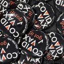 Closeup of a pile of COVID VAX buttons