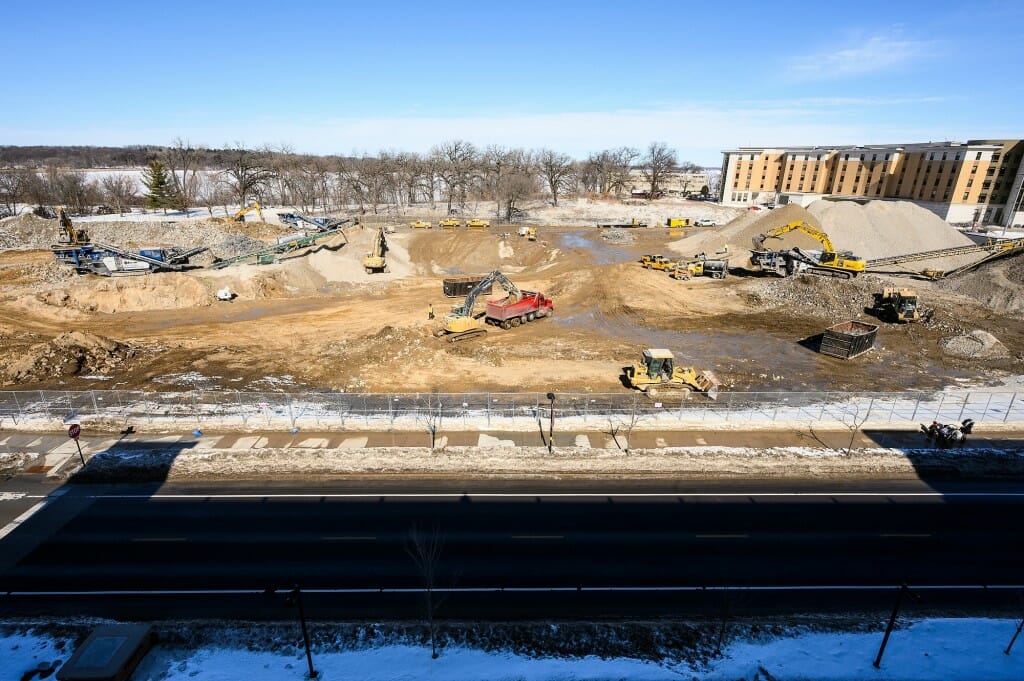 Construction workers use heavy equipment to grind remaining rubble piles from the demolished 1960s-era Natatorium. Construction of a new Natatorium is expected to begin in spring.