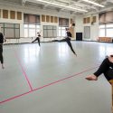 Students perform within their designated 10-feet by 12-feet rehearsal sections during Dance 112: Contemporary Dance Technique and Theory II. The in-person class is taught by faculty associate Karen McShane-Hellenbrand, seated at right, in Lathrop Hall on April 23.