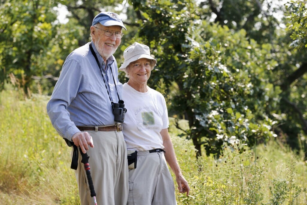 Tom and Kathie Brock walking in the prairie