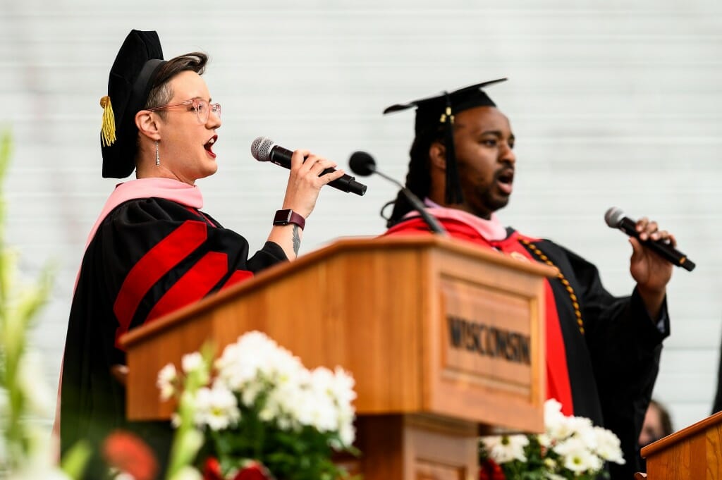 Photo of Brailey and Stokes at the podium, singing.