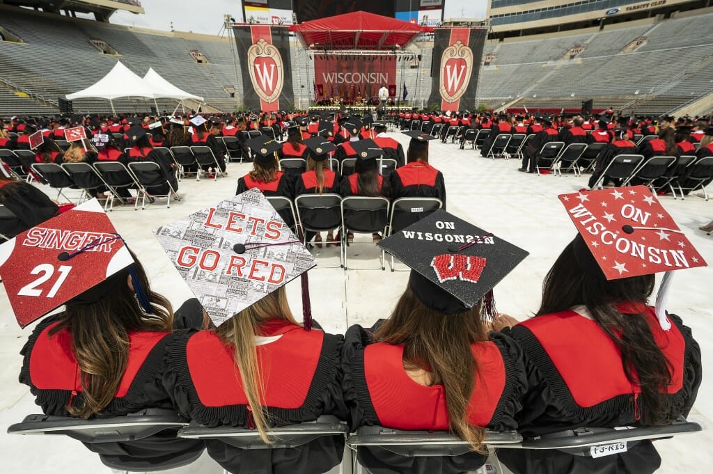 Mortarboards reading "Singer 21," "Let's Go Red," and "On Wisconsin"