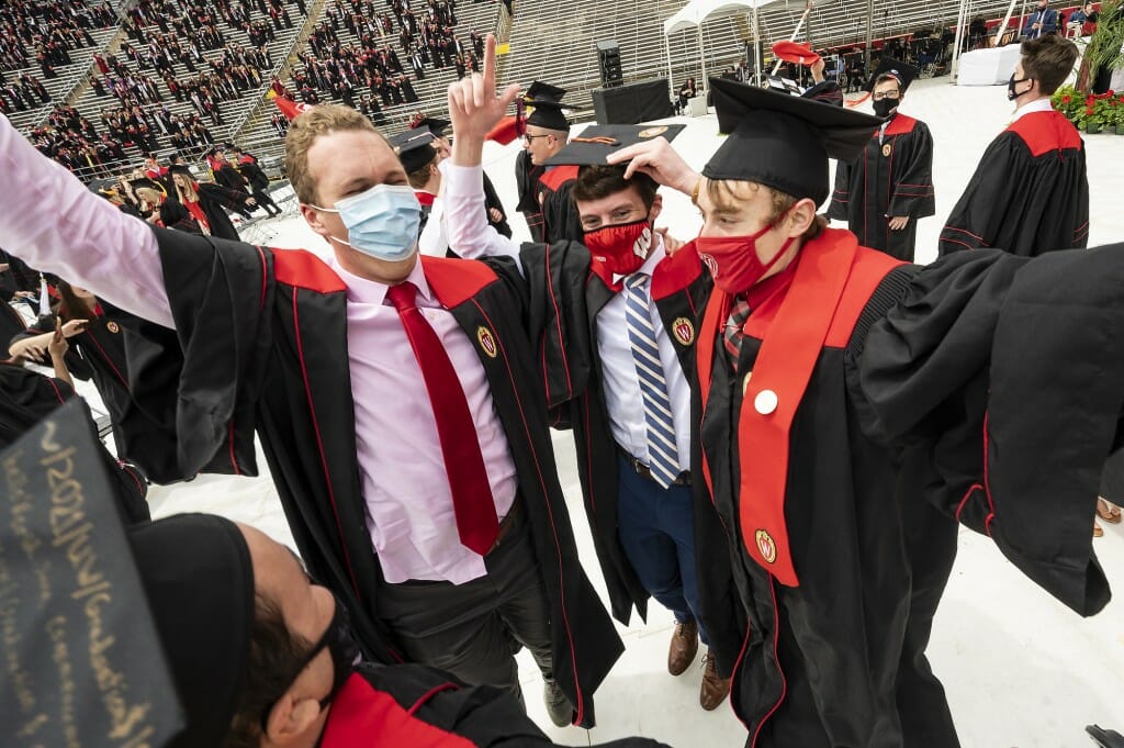 Photo of graduates jumping on the field