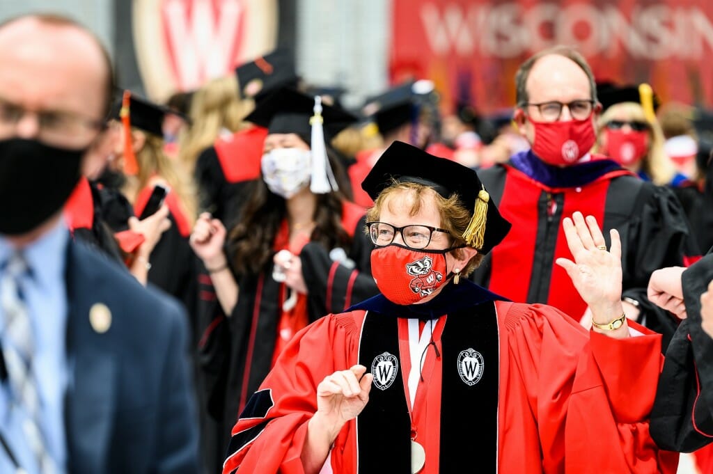 Chancellor Blank waves to graduates as they leave the stadium.