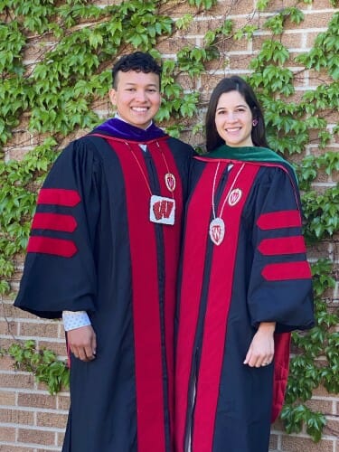 Photo of Gudino and Divine in their commencement robes