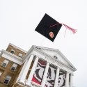 A cap and tassel being tossed in the air over Bascom Hall