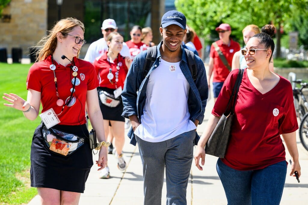 Guide and guests walking on sidewalk