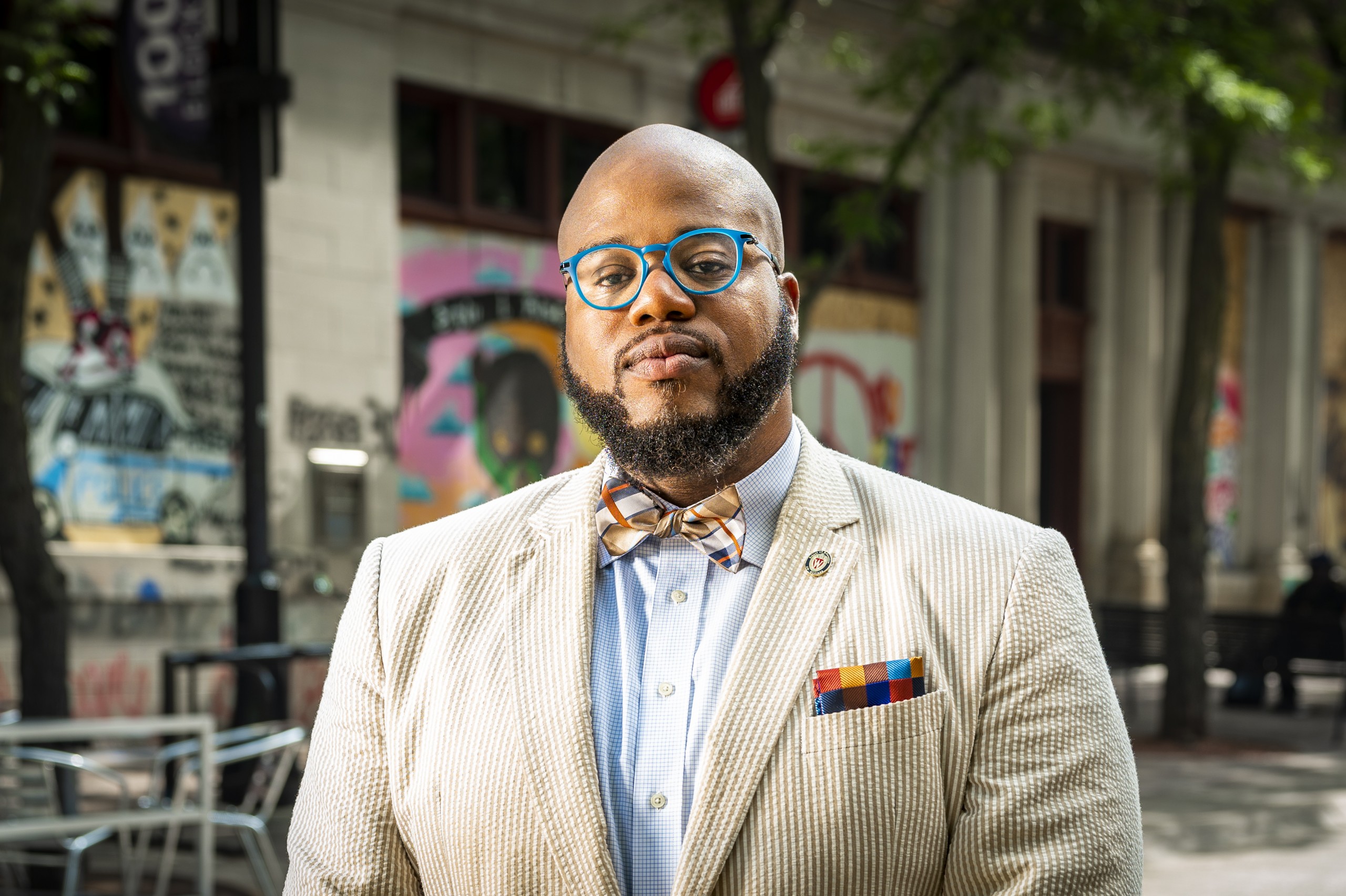 A photo of LaVar Charleston with State Street storefronts and murals in the background