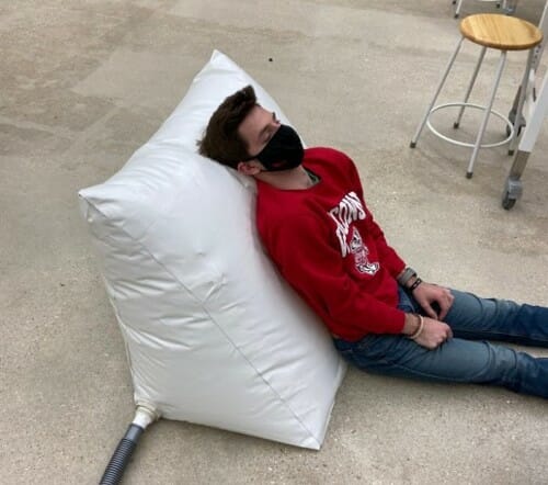 Person leaning against an inflated pillow