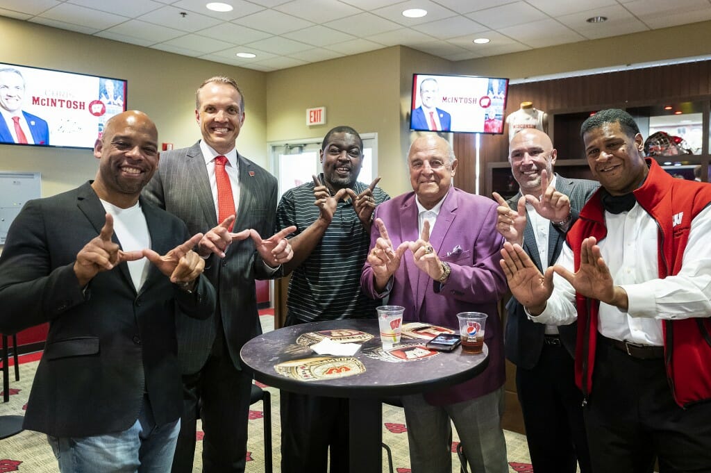 McIntosh (second from left) is pictured with his former teammates and coach Barry Alvarez following the press conference.