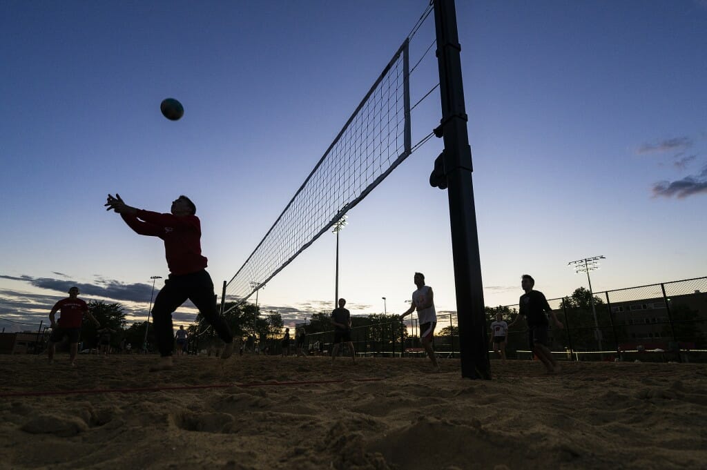 A rally continues as a player sets the ball.