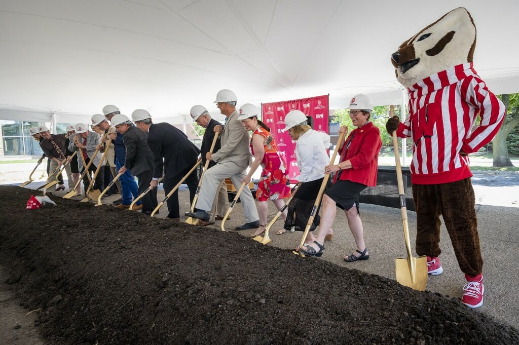 Bucky Badger and Chancellor Rebecca Blank stand with donors and other members of the campus and state community as they take shovels in hand during a UW School of Veterinary Medicine building expansion and renovation groundbreaking.