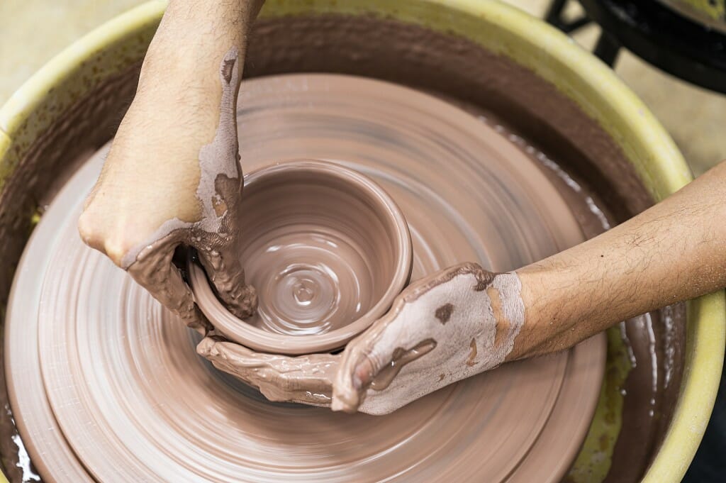 Closeup of person throwing a pot