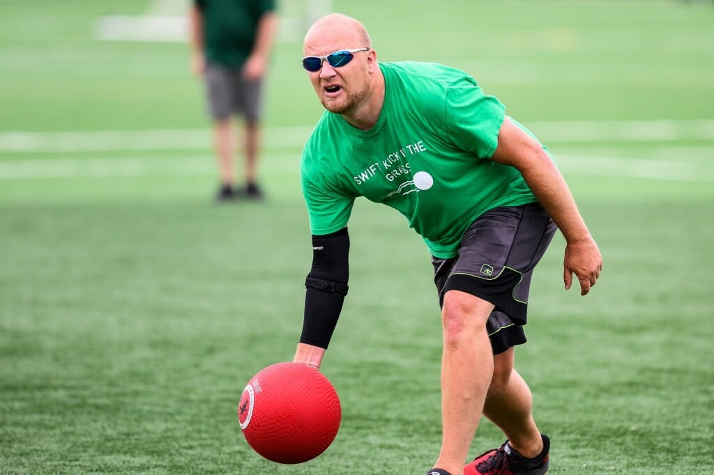 Brian Zimmermann with the Office of Human Resources rolls a pitch to the kicker at the plate.