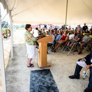 Rebecca Blank speaks at a podium to a seated crowd.