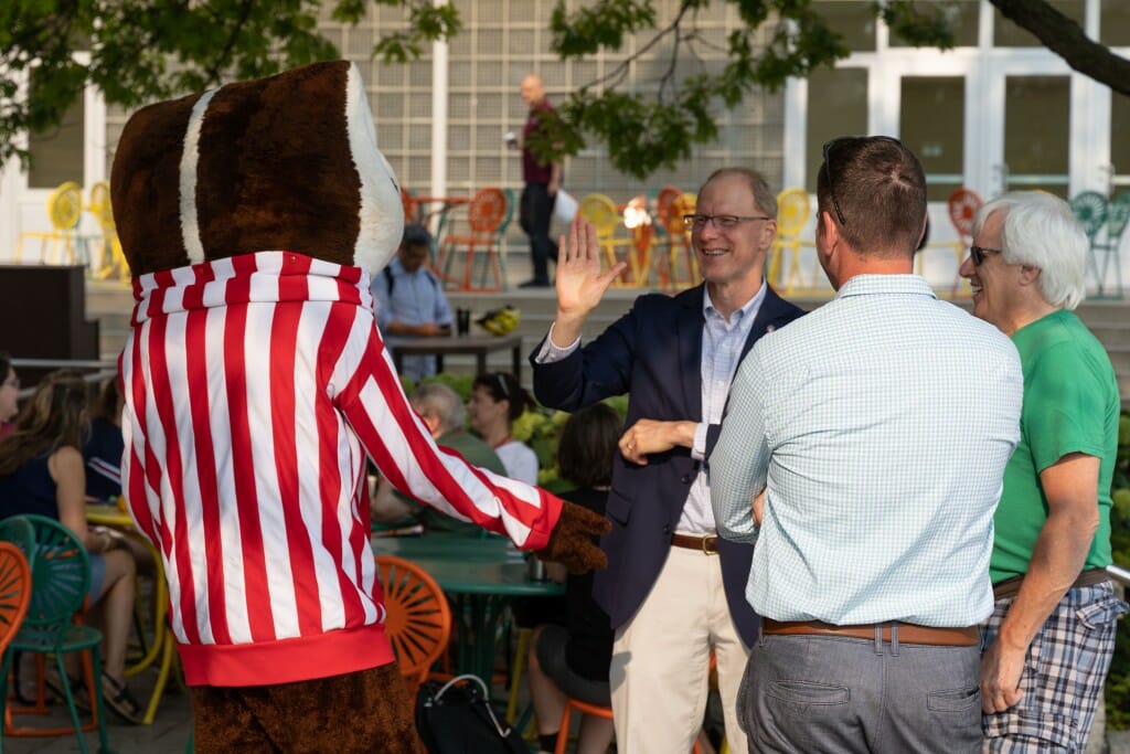 Bucky Badger has a conversation with some people.