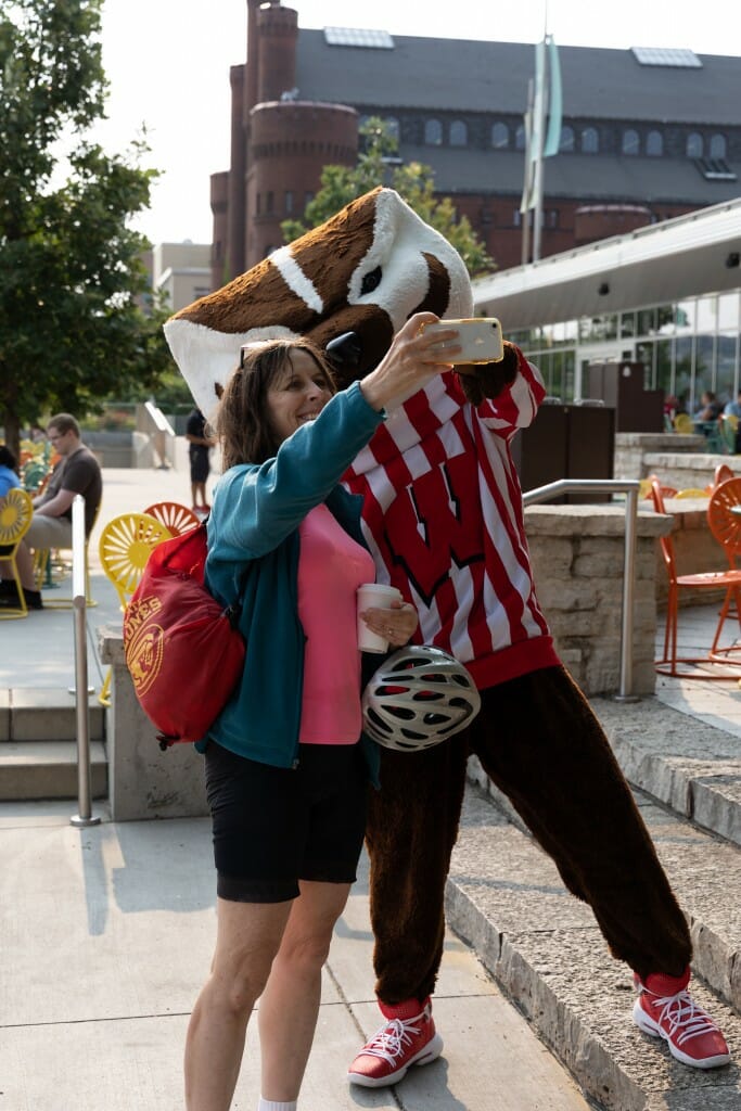 Bucky and an employee take a selfie together.