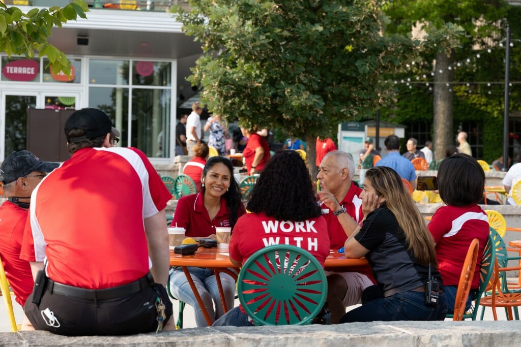 People sitting at a table laugh and joke with each other.