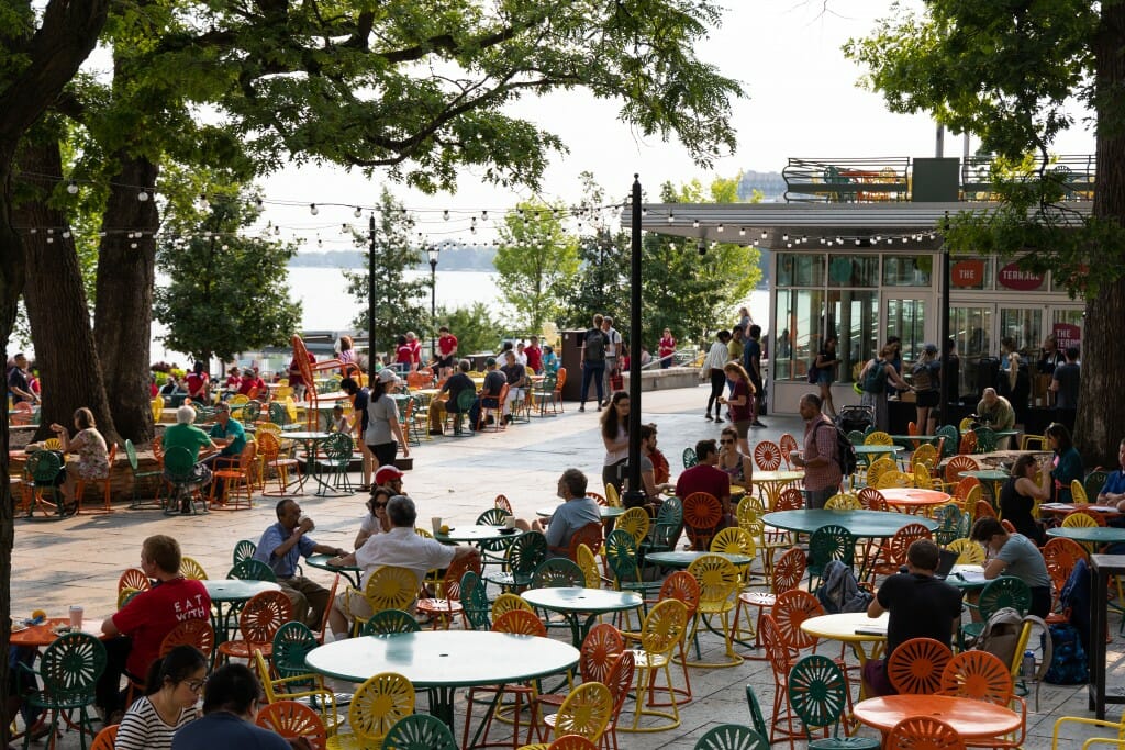 People sitting at tables on the terrace.