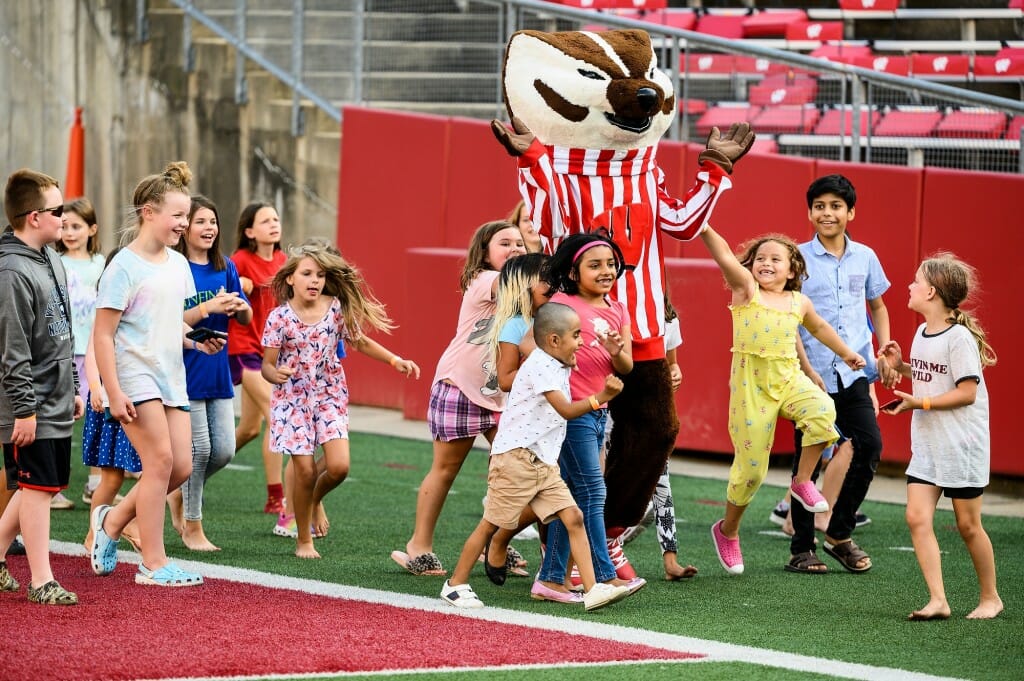 Kids running with Bucky Badger.