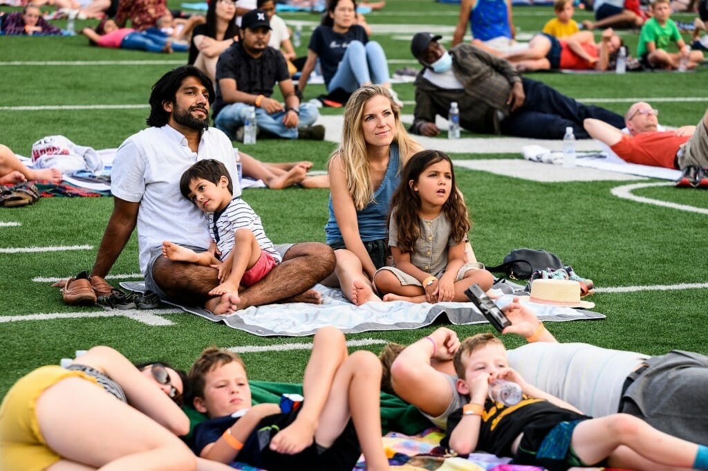 At upper left, Kabeer Shah, adjunct faculty in the Department of Pathology in the School of Medicine and Public Health, his wife, Julia, and their children, Bodhi, 4, and Veda, 5, enjoy the movie.